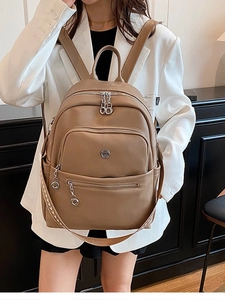 Brown faux leather fashion backpack with large front pocket and woven strap for women