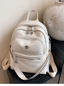 Chic ivory faux leather backpack with wide patterned strap and silver hardware