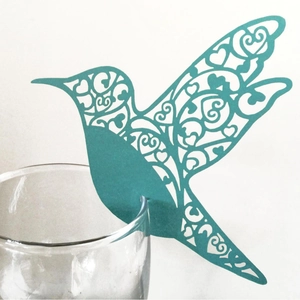 Laser cut hummingbird place card in teal paper for wedding glass decoration