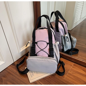 Detail of pink and grey backpack with elastic drawstring and zipped front pocket