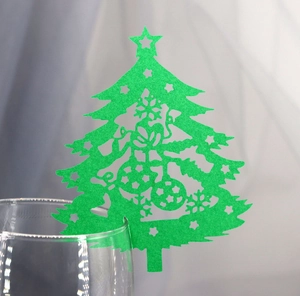 Green hollowed-out Christmas tree place cards for wine glass decoration