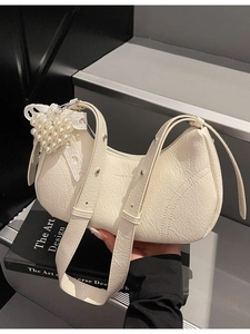 Chic cream ruched underarm bag with silver rivets and elegant pearl heart pendant
