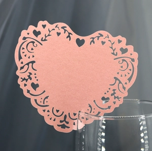 Pink heart laser cut place cards with hollow vine patterns for elegant wedding decor