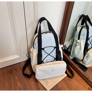 Close-up of light blue nylon backpack set with mini pouch and KMD 2ND logo details