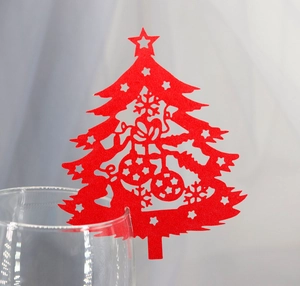 Red laser-cut Christmas tree wine glass cards with hollow snowflake and star patterns