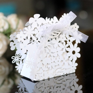 Elegant white laser-cut hollow candy box with ribbon for wedding and party favors
