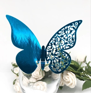 Detail of metallic blue 3D butterfly glass card with laser-cut hollow pattern and shiny finish