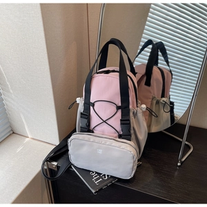 Detail of pink and grey nylon multi-functional backpack set with a small zipper pouch