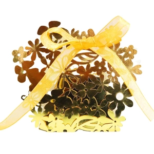 Golden laser-cut wedding favor box with hollow floral patterns and yellow organza ribbon