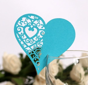 Intricate laser-cut heart wine glass card with floral patterns in cyan for wedding decor