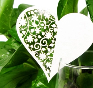 White laser-cut heart paper place cards for wedding glass decoration and seating