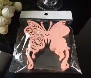 Detail of pink laser-cut butterfly wine glass cards with intricate hollowed patterns