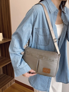 Khaki multi-pocket canvas shoulder bag for women shown as a stylish crossbody daily accessory