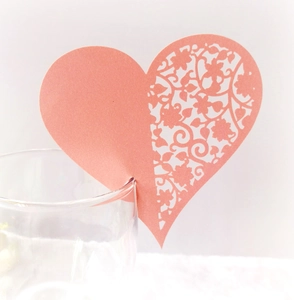 Pink heart laser-cut paper place card for glass decoration on white background