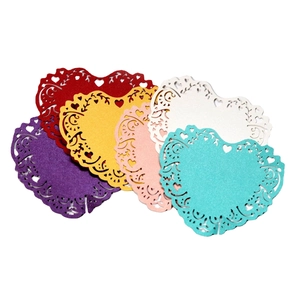 Hollow heart-shaped laser-cut wedding place cards in colorful assortment for tables