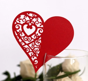Red laser-cut heart glass card with intricate hollow vine patterns for wedding decor