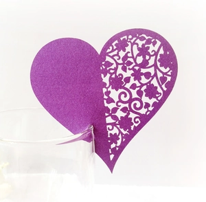 Elegant purple heart laser-cut name place card with floral patterns on glass rim