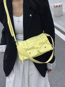 Minimalist light yellow crossbody bag with sweet bow accents and metal studs for women
