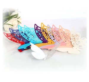 Close-up of laser-cut 3D butterfly cards in various colors with intricate hollow patterns