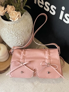 Chic pink pleated crossbody bag with dual decorative bows and front pockets for women