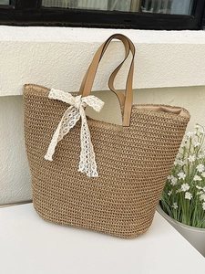 Large woven tote bag with lace bow and leather handles for summer beach vacations