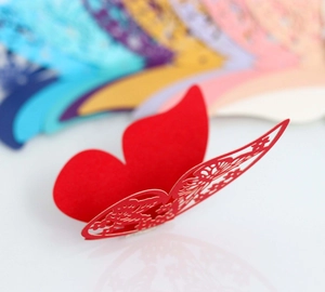 Detailed laser-cut hollow pattern on red paper butterfly for party cup card decoration