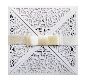 Laser-cut rose invitation cover with elegant cream satin ribbon bow and petal fold