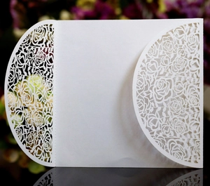 Elegant white laser-cut rose invitation card with intricate floral fold-out patterns