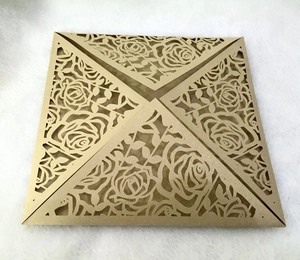 Detail view of laser-cut rose patterns on elegant golden square invitation cover