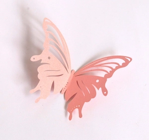 Macro shot of 3D laser-cut hollow butterfly wall sticker in pearlescent pink cardstock