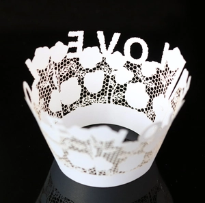 Detailed laser-cut white cupcake wrapper with LOVE lettering and rose lace pattern
