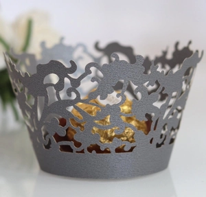 Intricate laser-cut dark gray lace cupcake liner with floral pattern and pearl finish