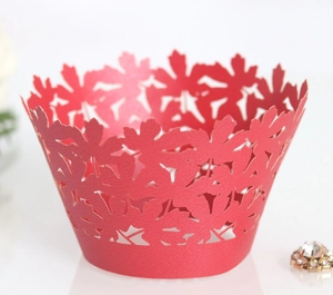 Detailed laser-cut red cupcake wrapper featuring elegant leaf patterns and hollow design