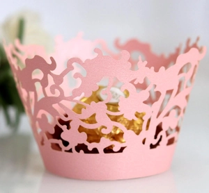 Pink laser cut cupcake wrappers with elegant vine patterns for wedding party decor