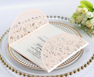 Elegant laser-cut butterfly wedding invitation with white insert on decorative plate