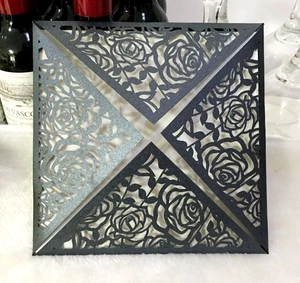 Detail of laser cut rose pattern on elegant black square invitation cover envelope