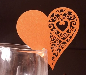 Laser-cut heart-shaped place card with orange floral filigree for glass decoration