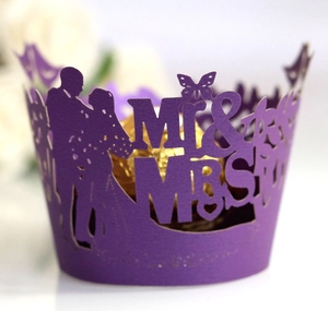 Purple laser-cut Mr & Mrs cupcake wrappers with wedding silhouettes and butterflies