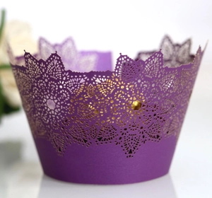 Deep purple laser-cut cupcake wrappers with elegant lace snowflake patterns for events