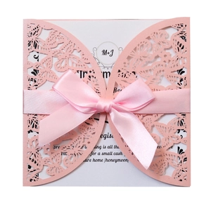 Pink laser-cut butterfly invitation card with white insert and satin ribbon bow
