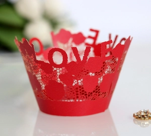 Detailed laser-cut red lace cupcake wrapper featuring LOVE and heart hollow designs
