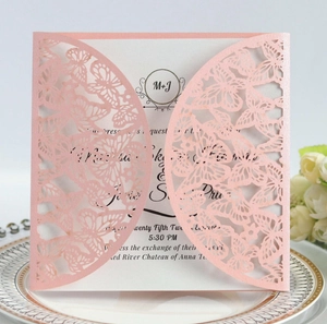 Laser cut butterfly wedding invitation in shimmer pink paper on an elegant plate