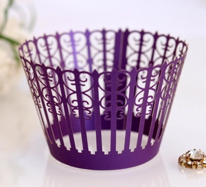 Detail showing the intricate laser-cut European lace patterns on a dark purple cupcake wrapper