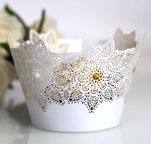 Detailed laser cut lace cupcake wrappers in white flower pattern for wedding decor