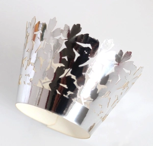 Laser-cut silver mirror cupcake wrapper with hollow floral patterns and leaf designs