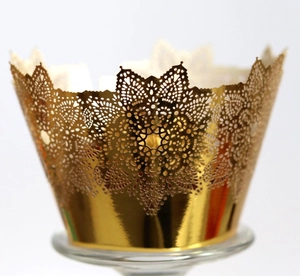 Golden laser-cut lace cupcake wrappers with intricate floral crown hollow design