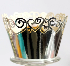 Macro view of laser-cut silver heart cupcake liners with reflective metallic finish
