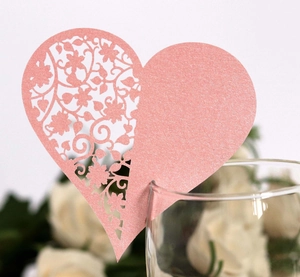 Laser-cut heart-shaped place card in pearlescent pink for wedding wine glass decoration