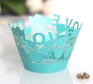 Detail of Tiffany blue lace cupcake wrapper featuring intricate laser-cut LOVE lettering