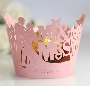 Pink laser-cut cupcake wrappers with Mr & Mrs butterfly design for wedding decor